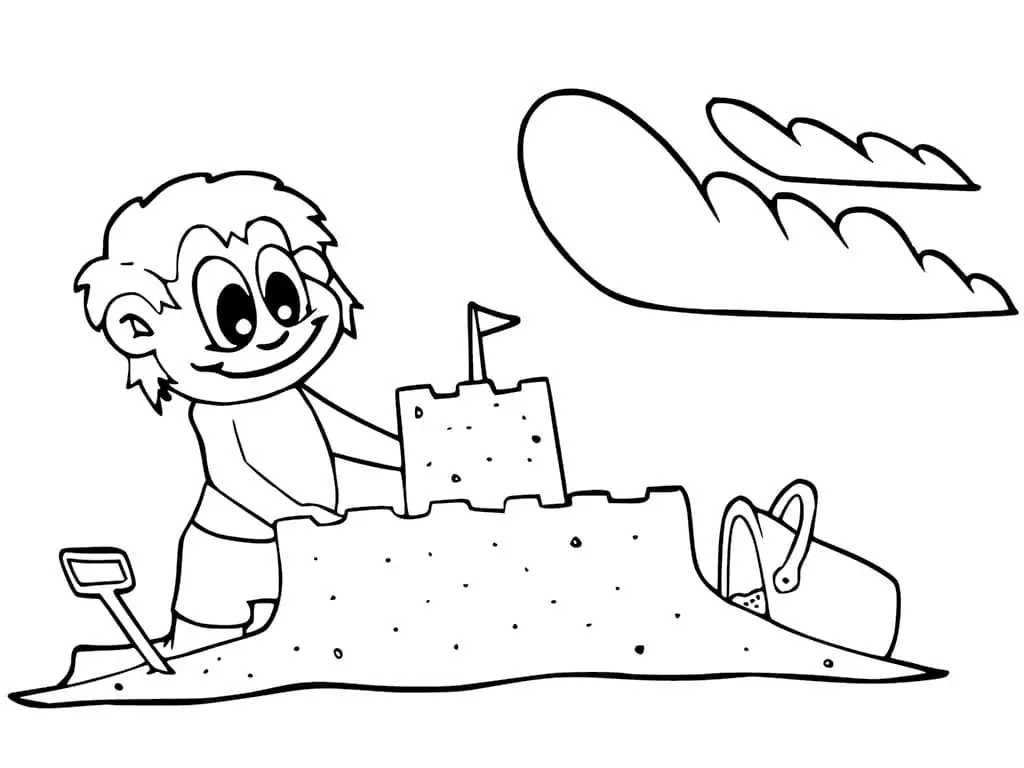 A Boy Building A Sand Castle